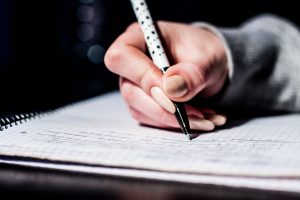 someone writing in a notebook