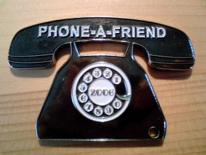 charm of telephone with phone a friend written on it