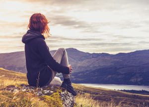 woman looking out over a lake