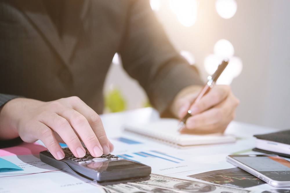 person in suit with calculator
