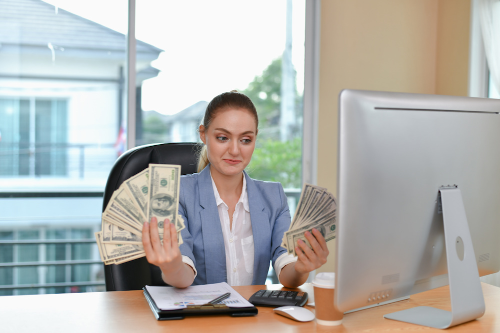 woman holding large amount of money