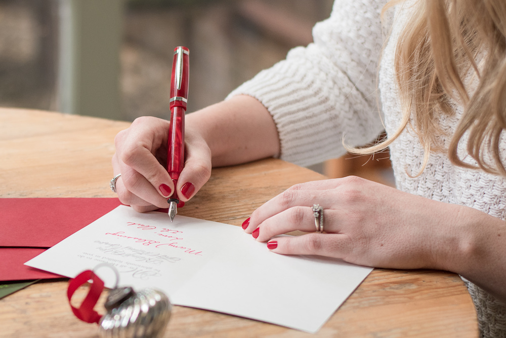 woman writing holiday cards