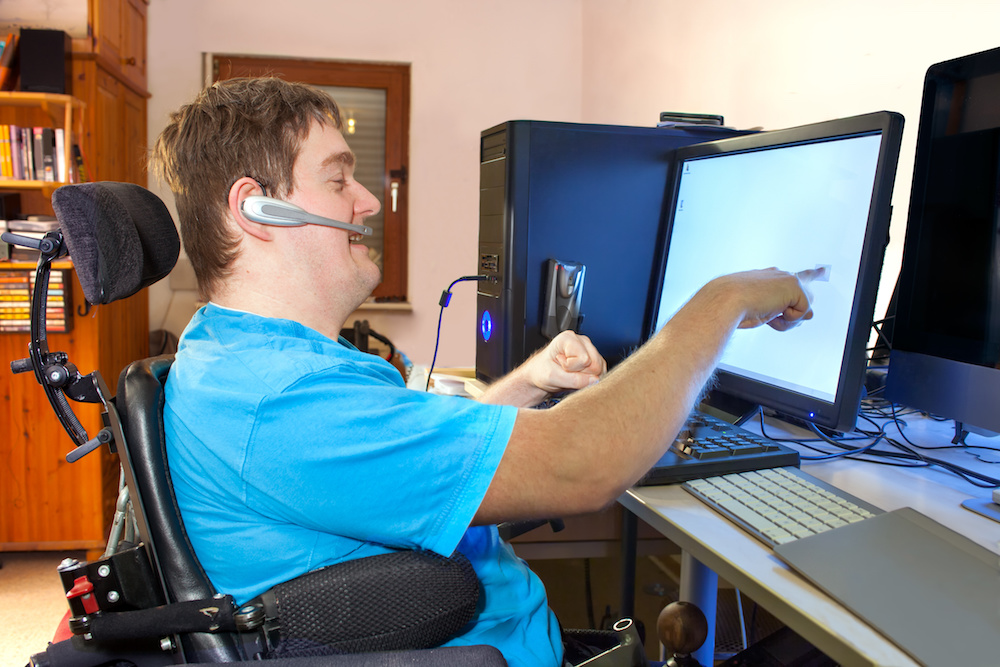 Man with infantile cerebral palsy using a computer