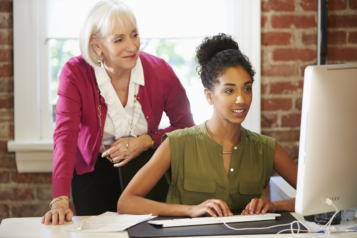 older woman mentoring younger woman
