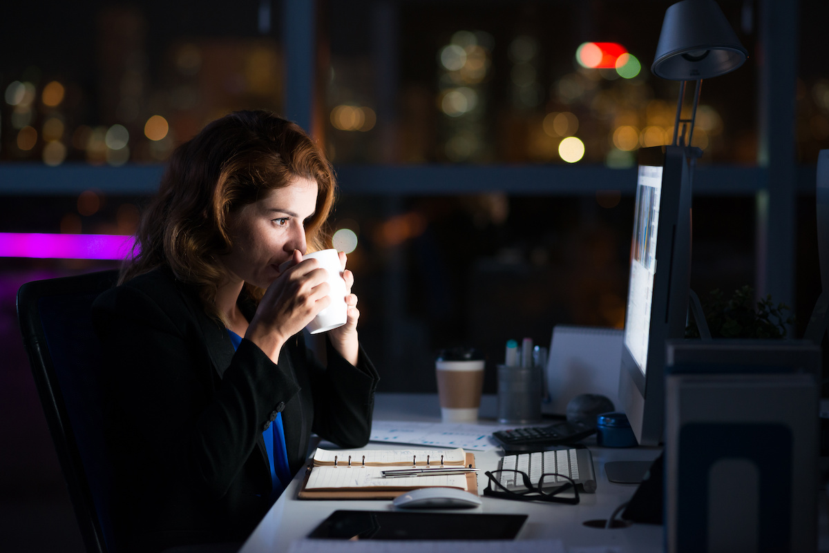 woman working at computer at night