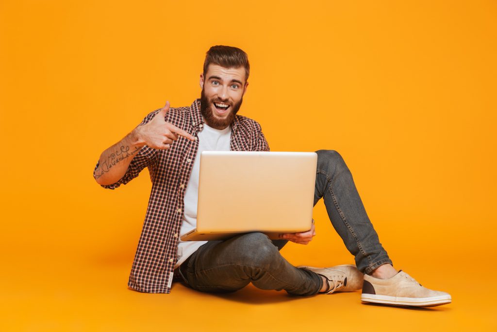 Man pointing to computer, excited about the launch of .dev
