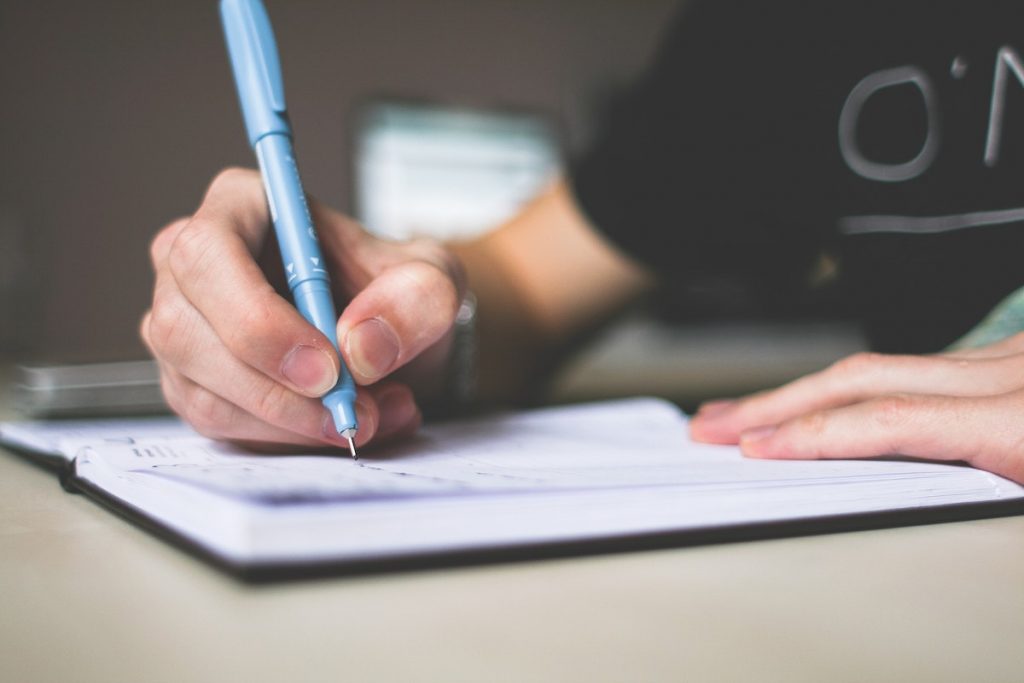man making a list in a notebook