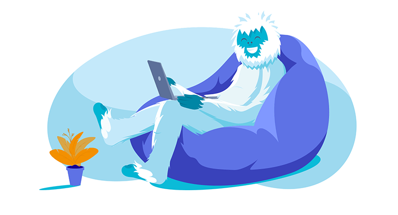 Yeti lounging in bean bag chair working on laptop