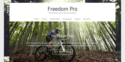 An example of the Freedom photography theme for WordPress featuring a man riding through the woods on a bicycle